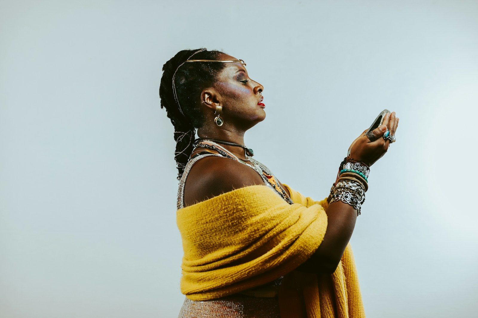 Woman in traditional attire with hands raised